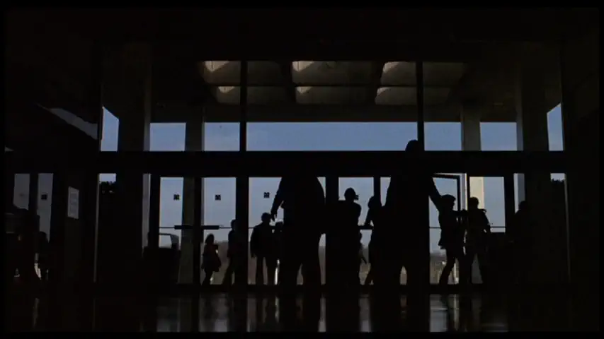 silhouettes of zombies entering the mall